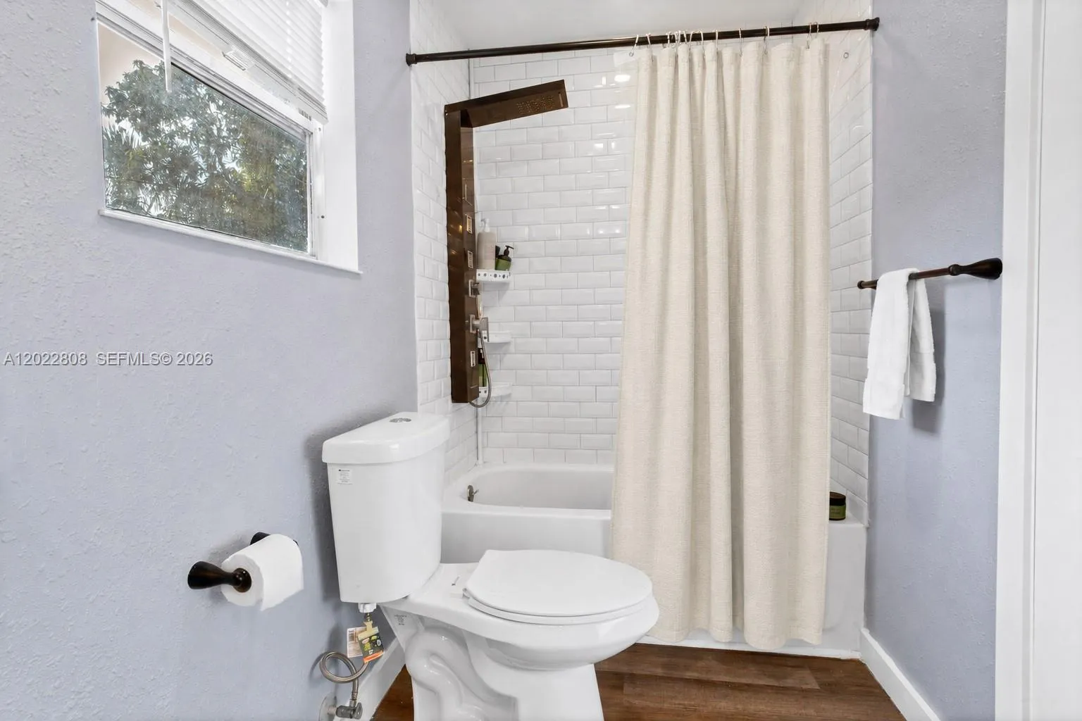 Beautifully updated bathroom with dual sinks, modern finishes, and a stylish tiled shower.