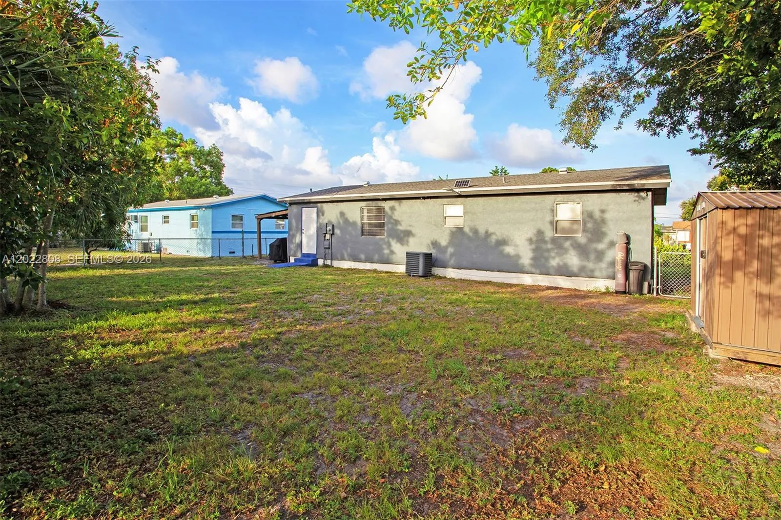 Private backyard retreat featuring a covered patio, ideal for outdoor dining, relaxing, and weekend gatherings.