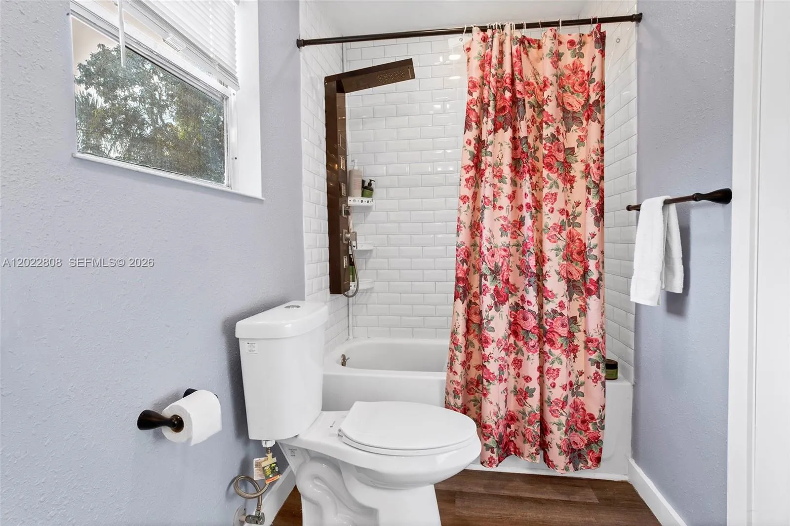 Beautifully updated bathroom with dual sinks, modern finishes, and a stylish tiled shower.