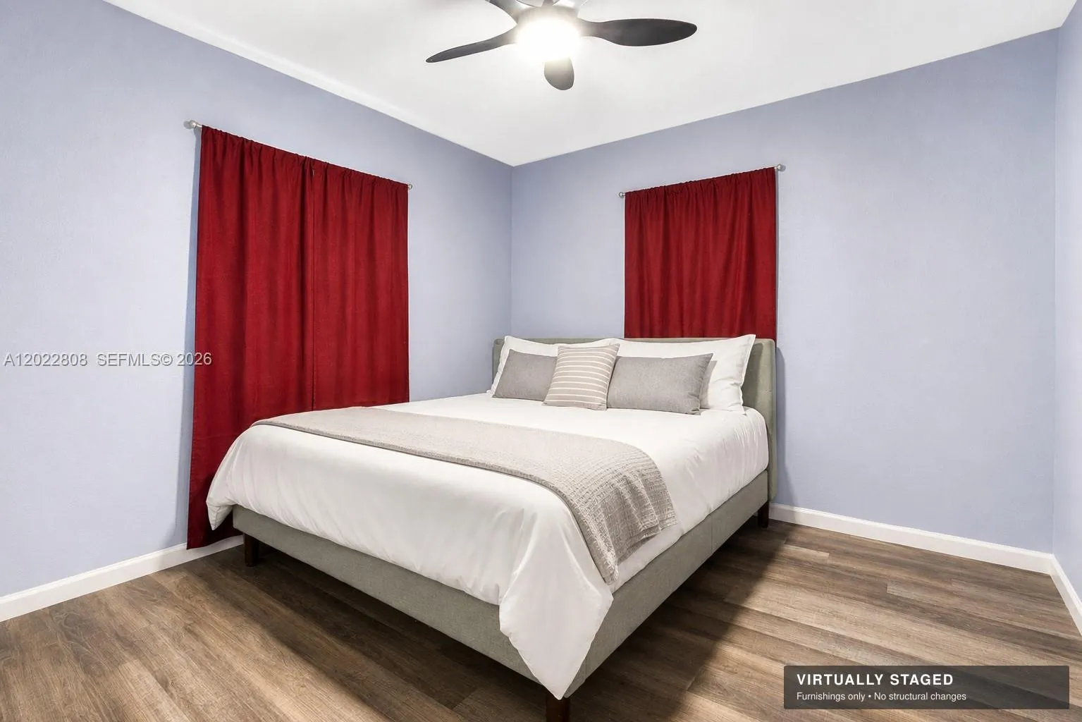 Spacious primary bedroom featuring modern flooring, abundant natural light, and a comfortable layout designed for relaxation.