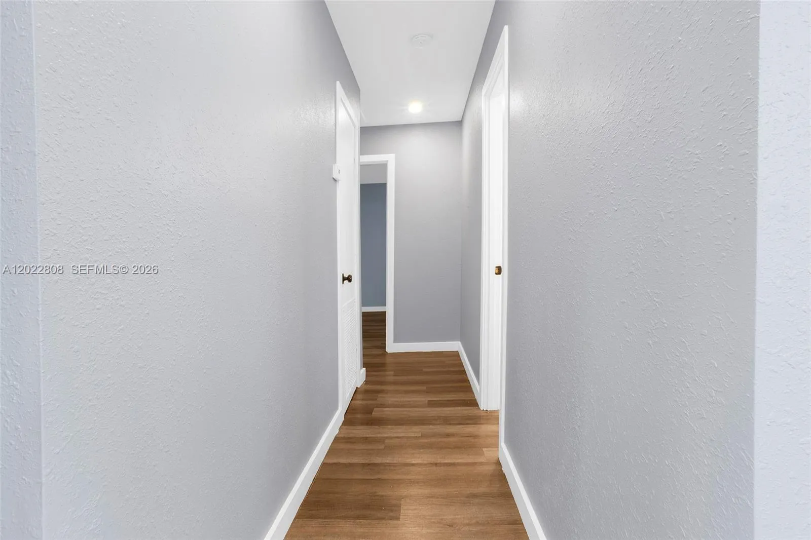 Bright and inviting hallway with modern finishes and seamless access to the home's private living spaces.