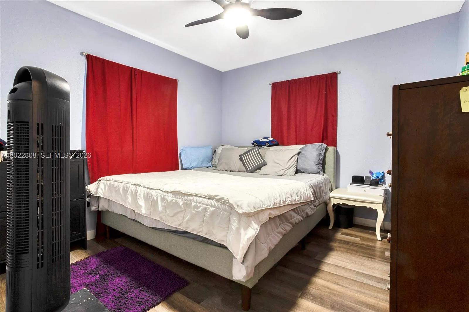 Spacious primary bedroom featuring modern flooring, abundant natural light, and a comfortable layout designed for relaxation.