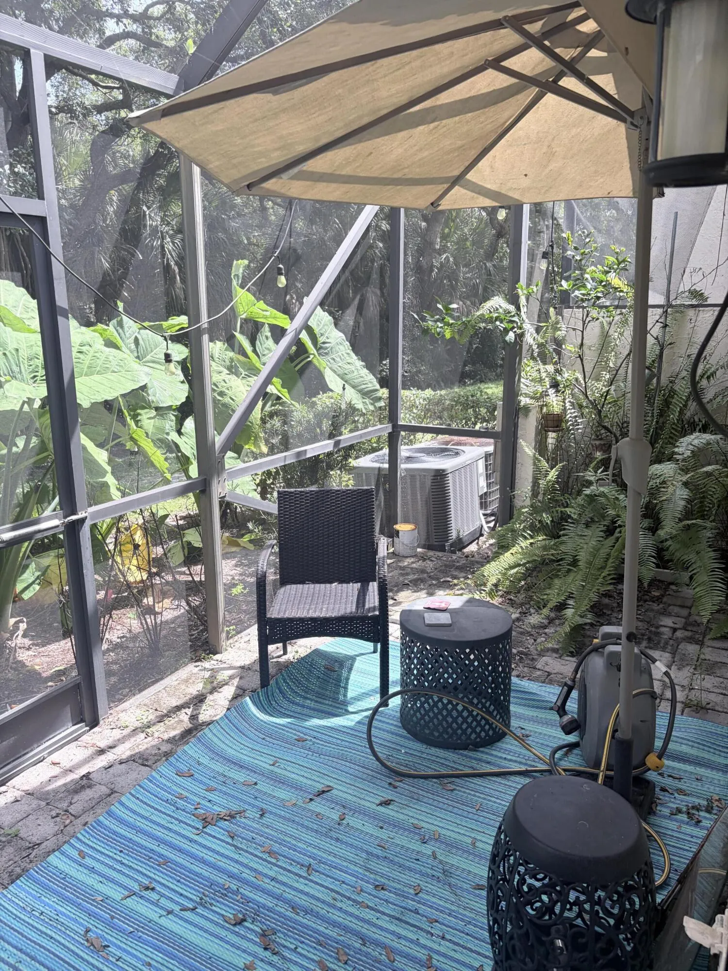 3rd patio in back with hottub views wooded area and walkway to the lake