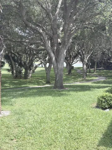 Corner unit offers nice open side yard area with walkway down to the lake