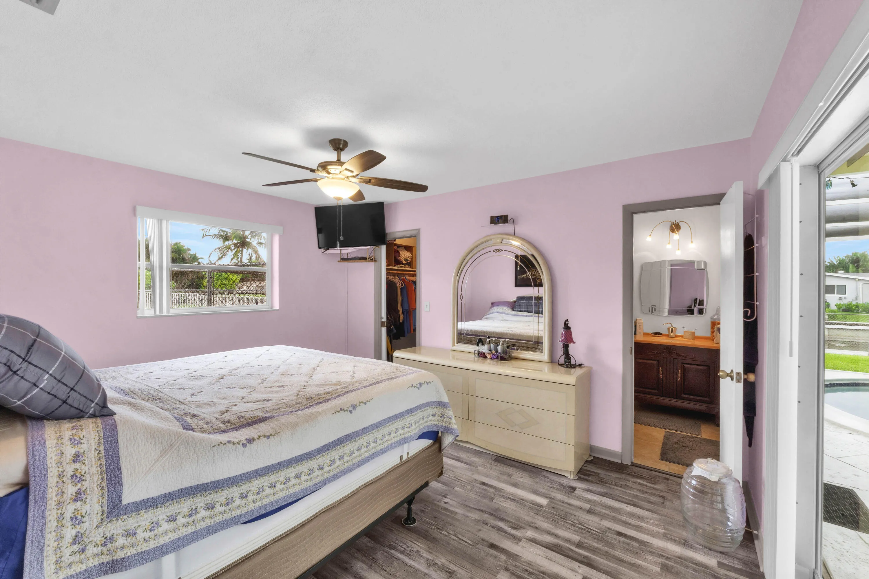 Primary Bedroom offers En Suite bathroom with Luxury Vinyl Plank Floors and Sliders to Patio