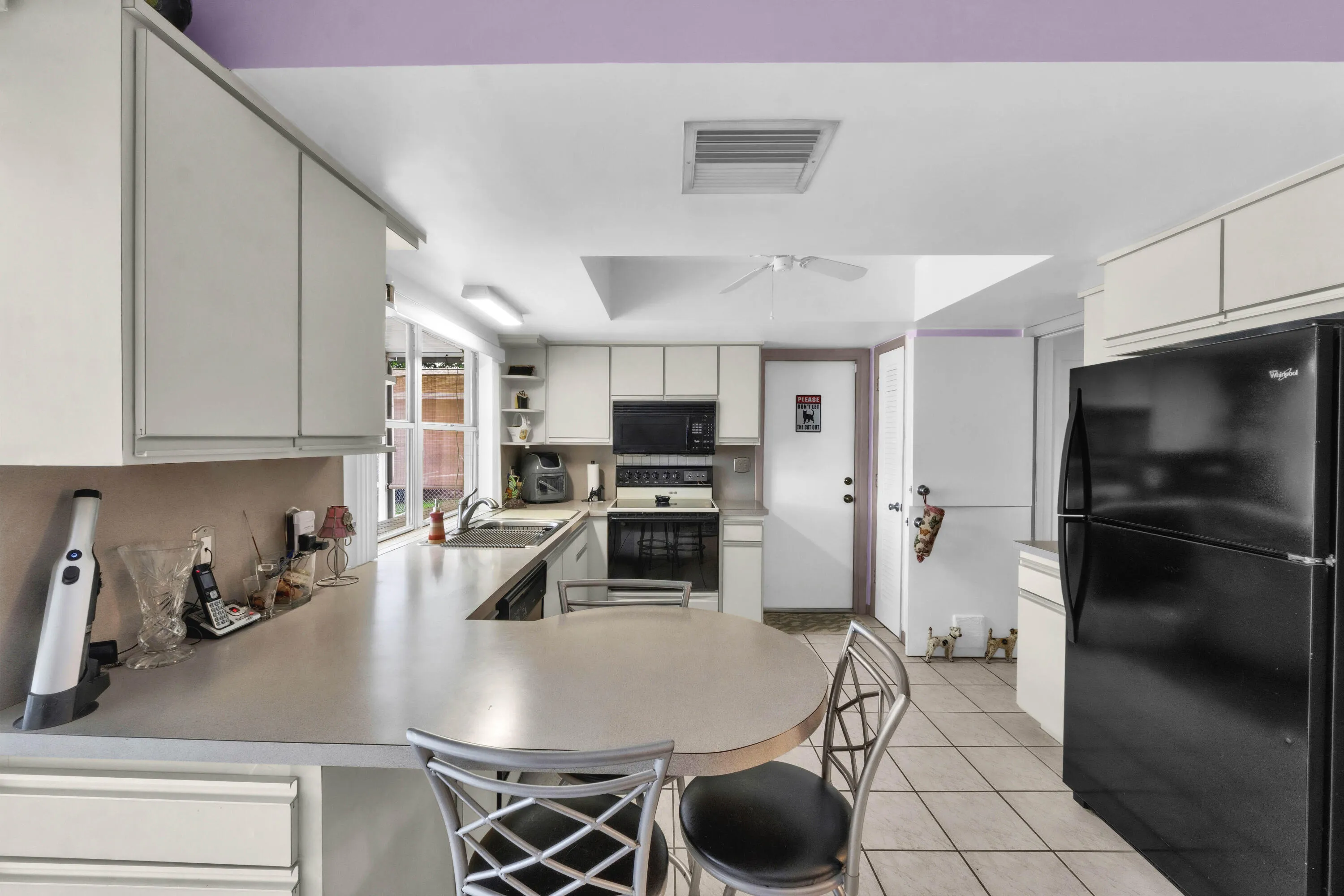 Breakfast Counter & Kitchen offers Neutral Cabinets, Pantry & Appliances. Easy Access to Garage.