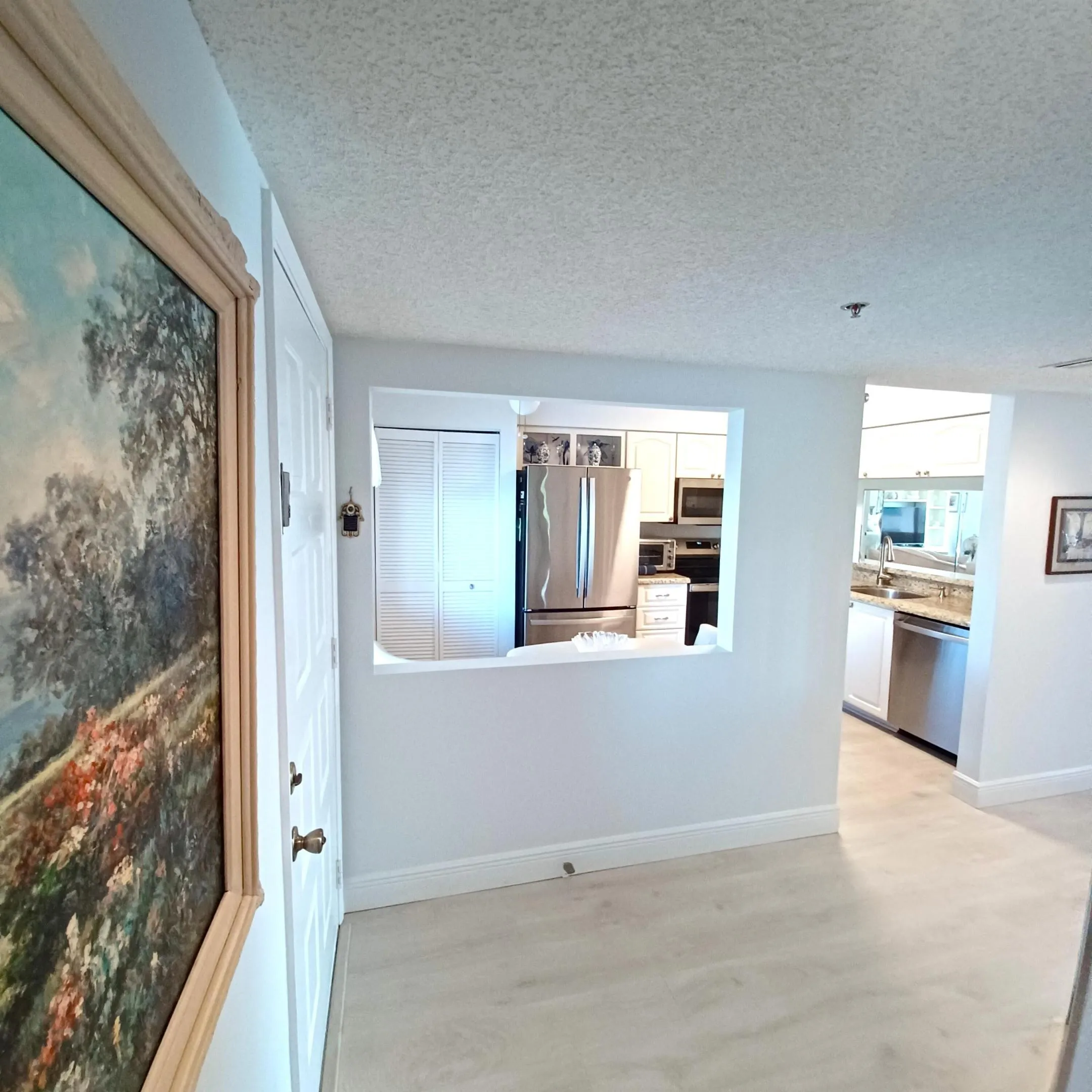 Kitchen from Hallway, wall open to sitting area