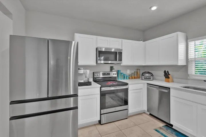 Stainless steel appliances including Samsung Bespoke refrigerator