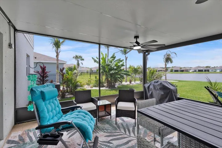 Screened-in back porch overlooks the landscaped backyard and lake