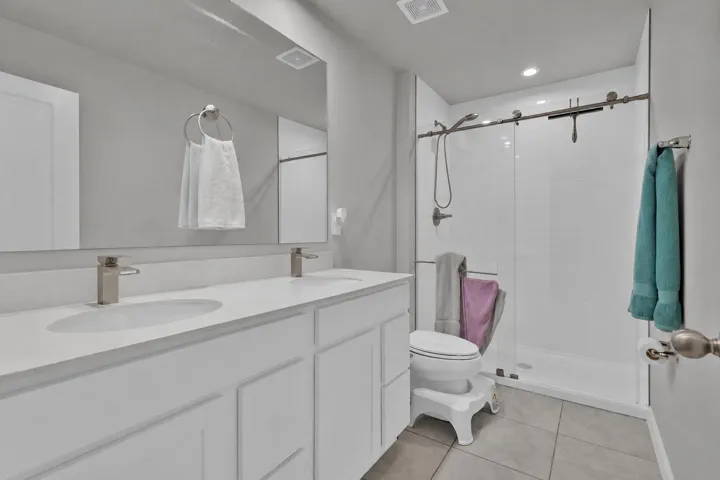 Dual sinks, glass shower enclosure