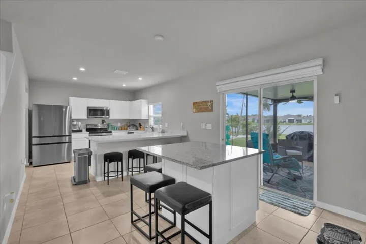 Opens to built-in dining area and sliding glass doors to rear lanai