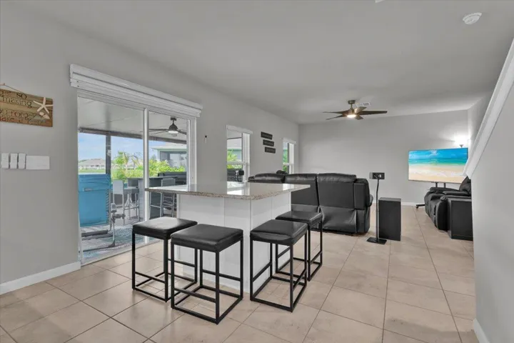 The added cabinets and countertop add storage and seating in the open kitchen and living area