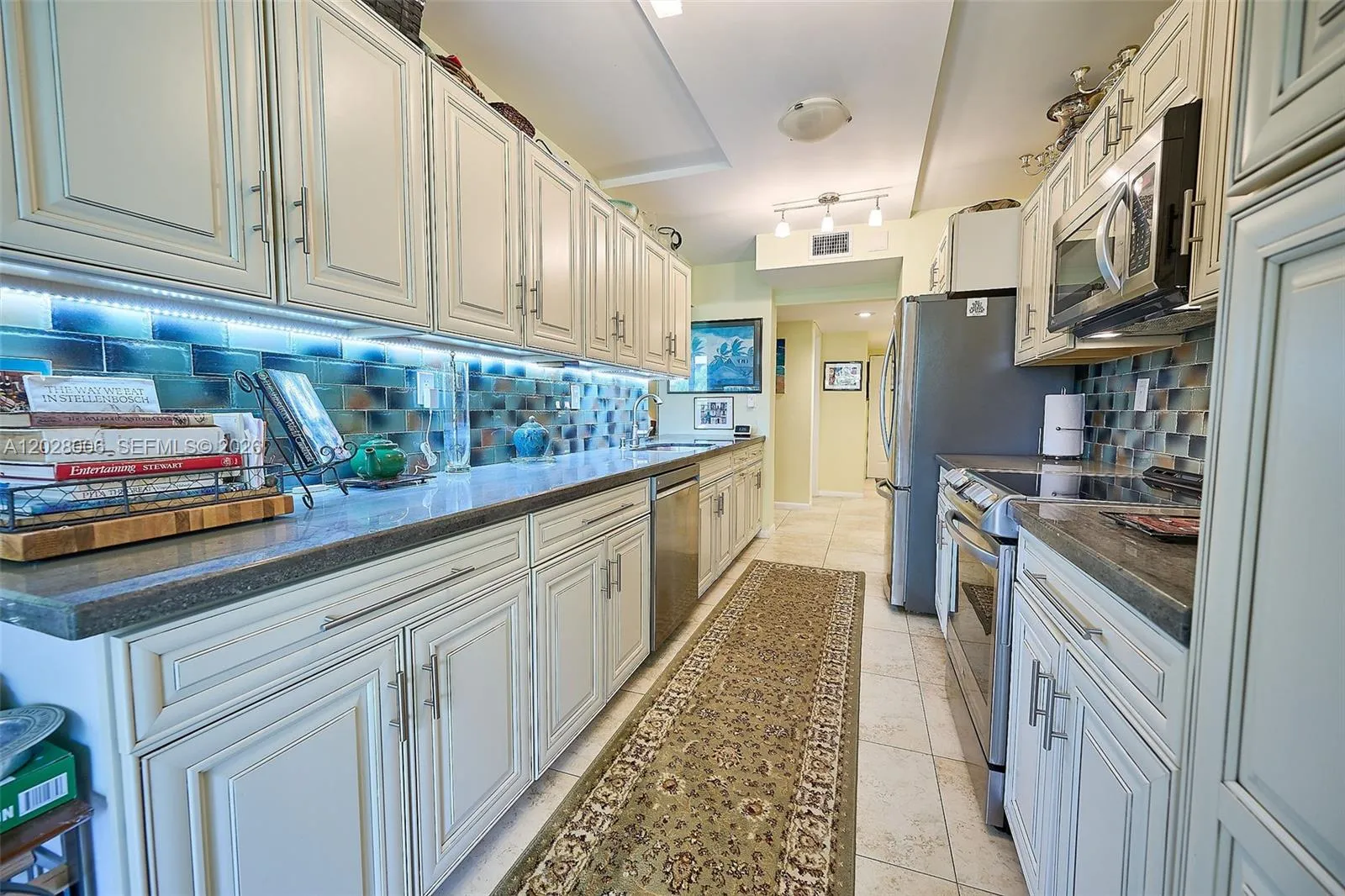 The galley kitchen features granite counters and soft-close drawers
