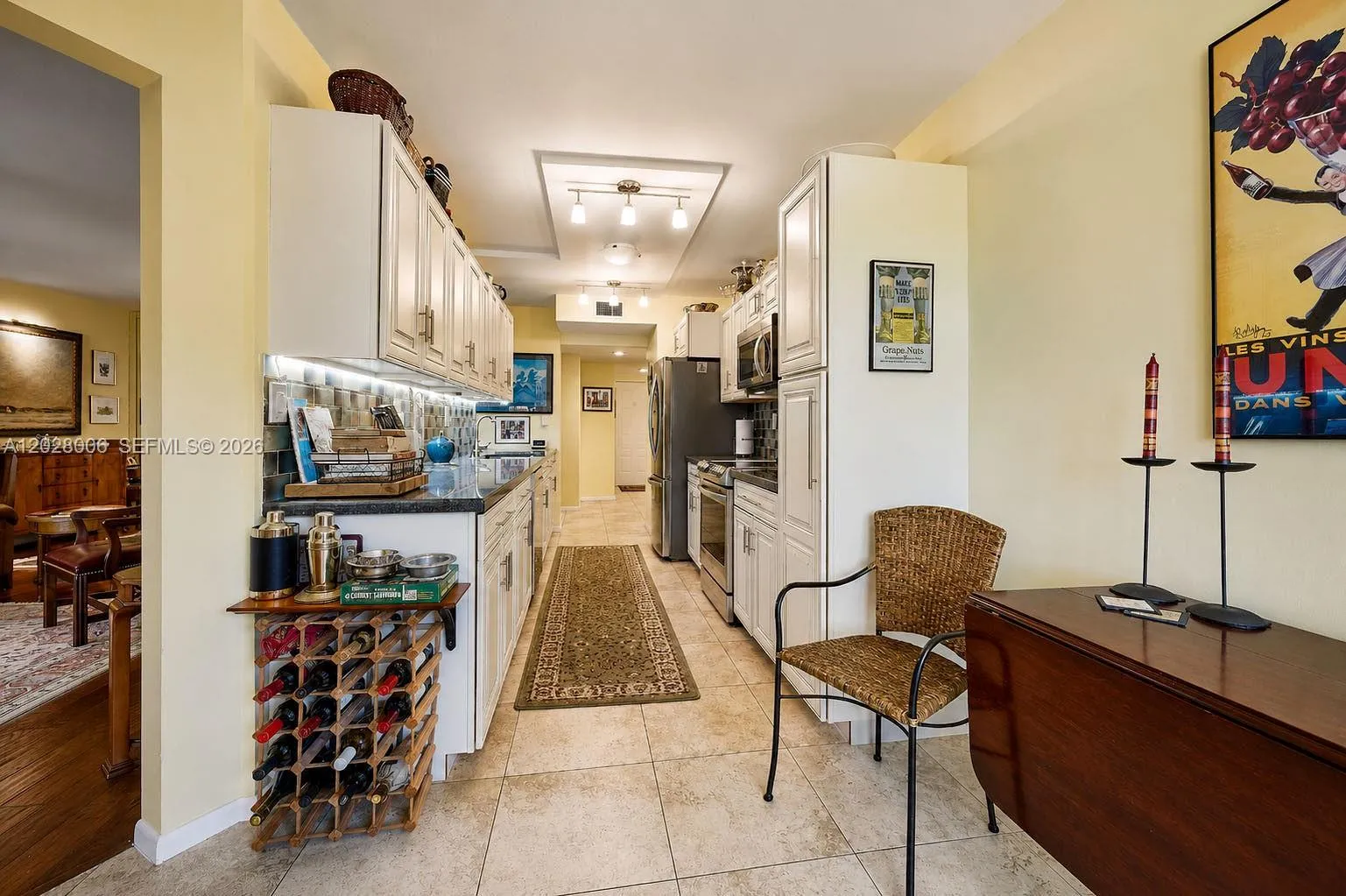 The galley kitchen boasts granite counters, stainless steel appliances, and soft-close drawers