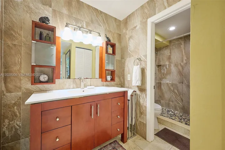 The primary bathroom is en suite, with a separate toilet and tiled shower.