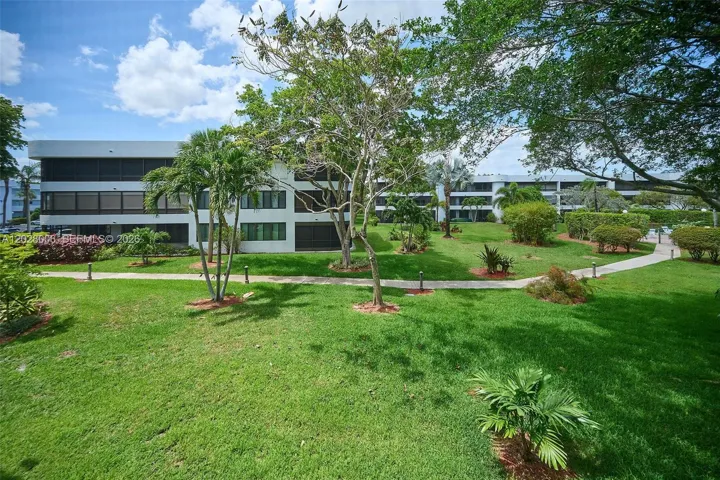 The lanai, which runs the width of the home, overlooks the park like grounds from this second-floor unit.