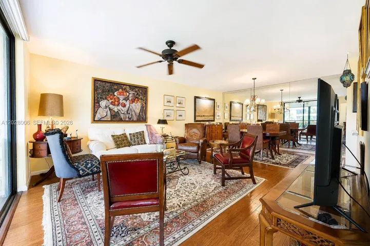The spacious living-dining room features a wall to wall mirror at one end, creating an even more spacious feel to the space, and reflecting the view of the beautifully landscaped grounds.