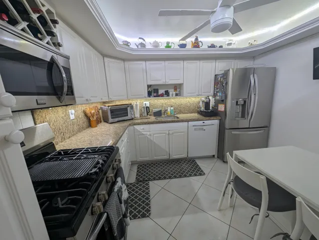 Kitchen Featuring Granite Top & Stainless Steel Appliances