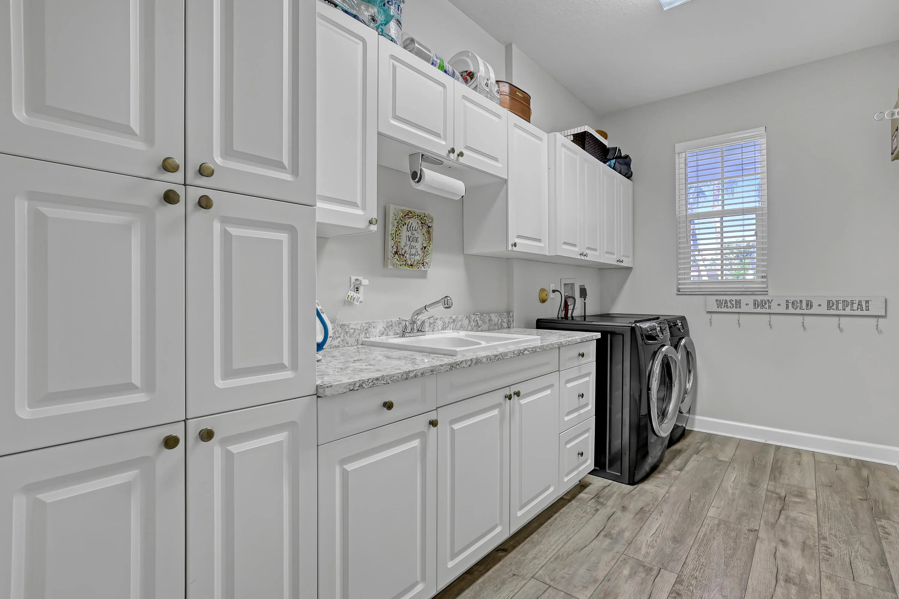 Laundry room with sink and storage