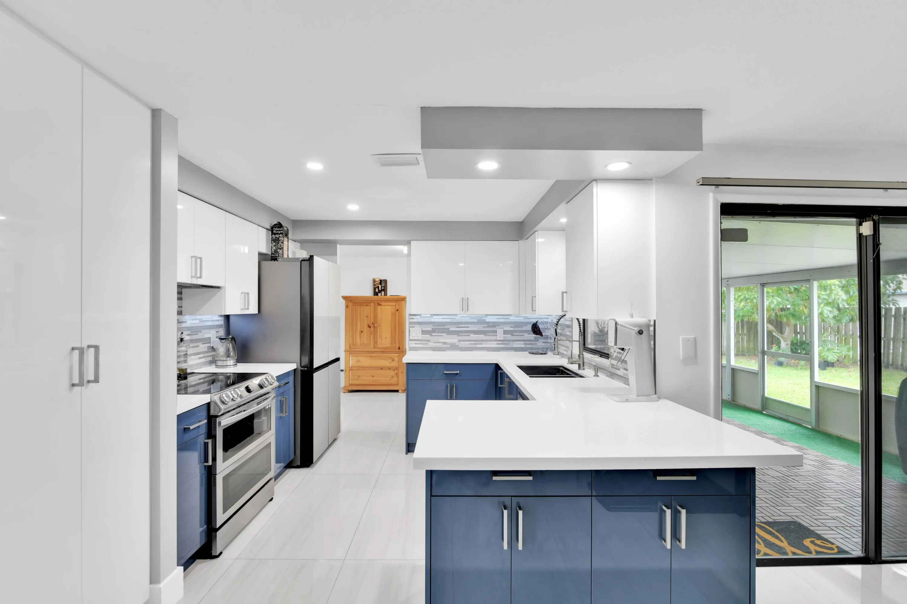 SLIDING GLASS DOORS TO PATIO. PANTRY HAS PULL OUT EASY CLOSE DRAWERS