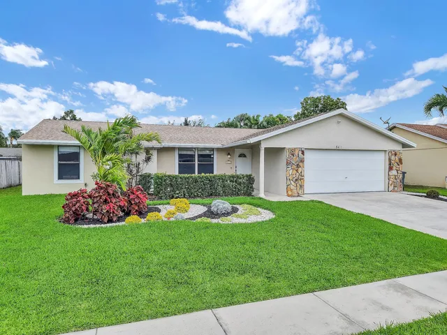 FRONT OF HOME WITH 2 CAR GARAGE & CUSTOM LAWN