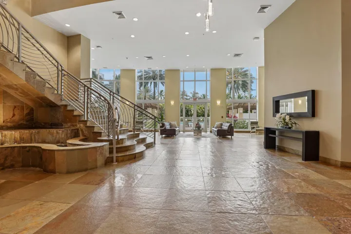 Luxurious space entering in the lobby with water feature and view of the pool.