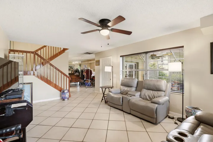 Large windows fill the living room with natural light, creating a bright and inviting space to gather and relax.