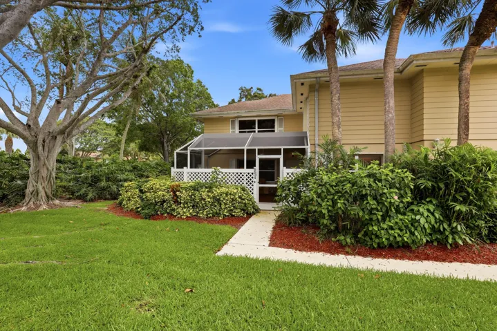 Surrounded by mature landscaping, this home offers a peaceful, park-like setting just steps from the community pool.