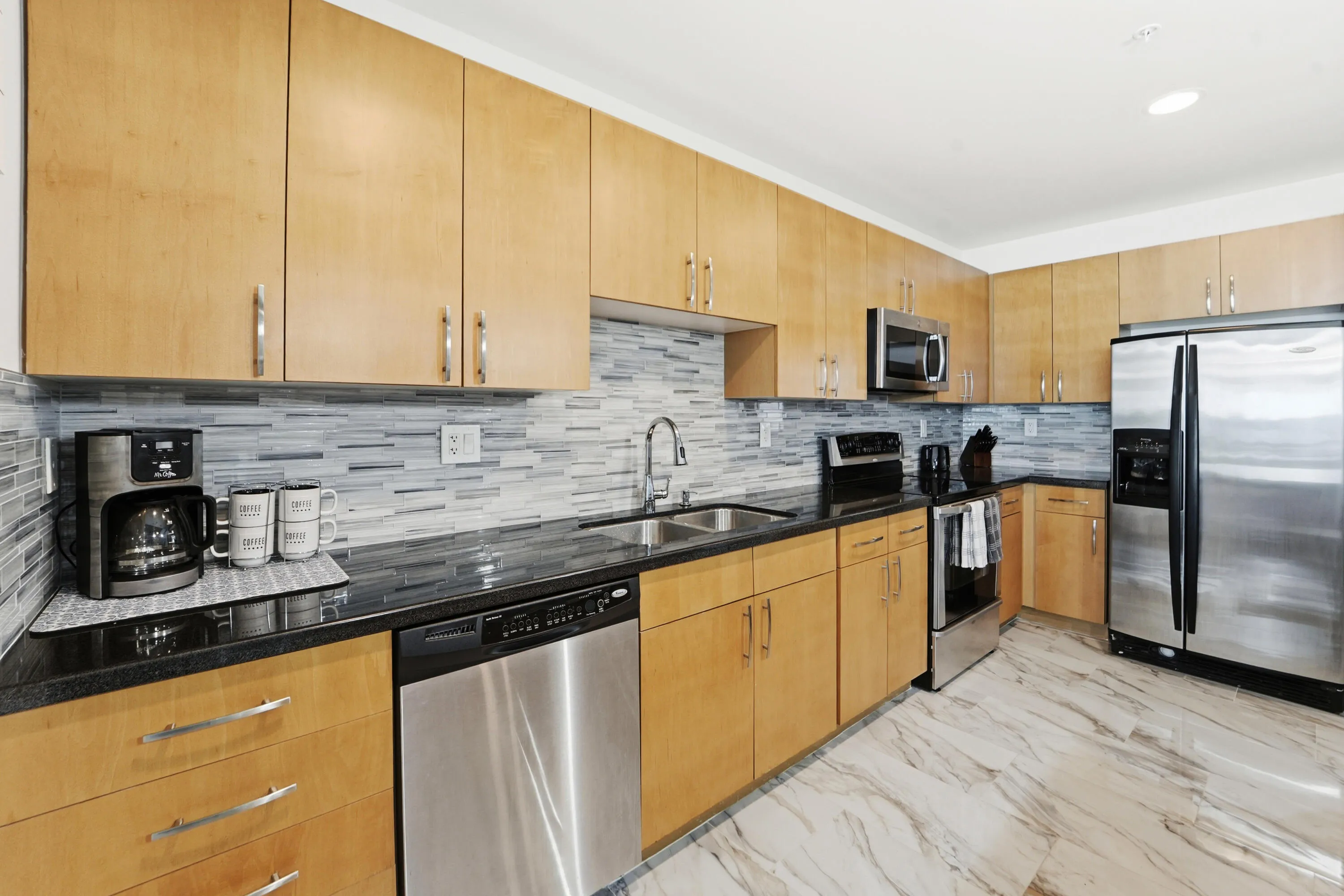 Open-concept kitchen with ample cabinetry, pantry, and island