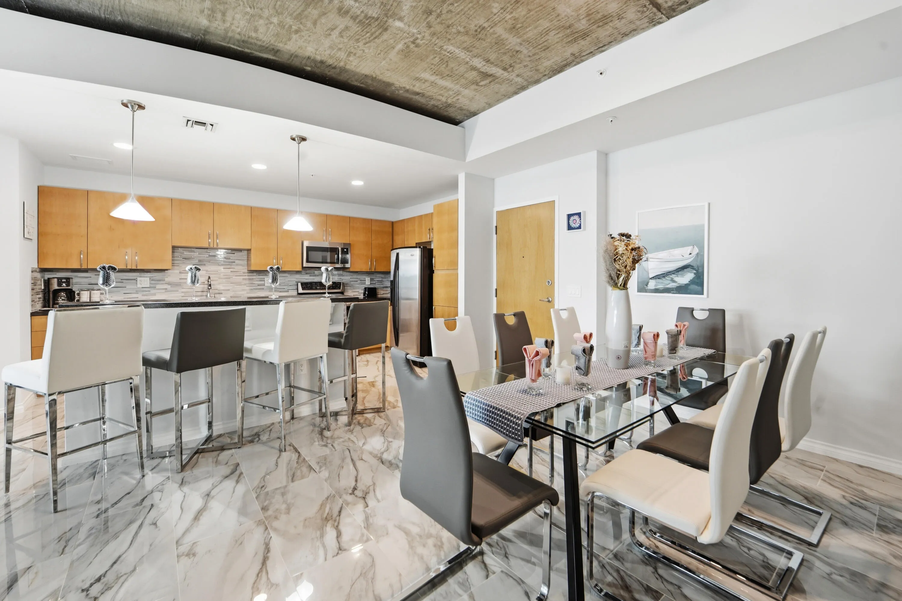 Dining table expandable to seat up to eight people with leather chairs. Collapsable, too, in the event you would like to seat fewer people.