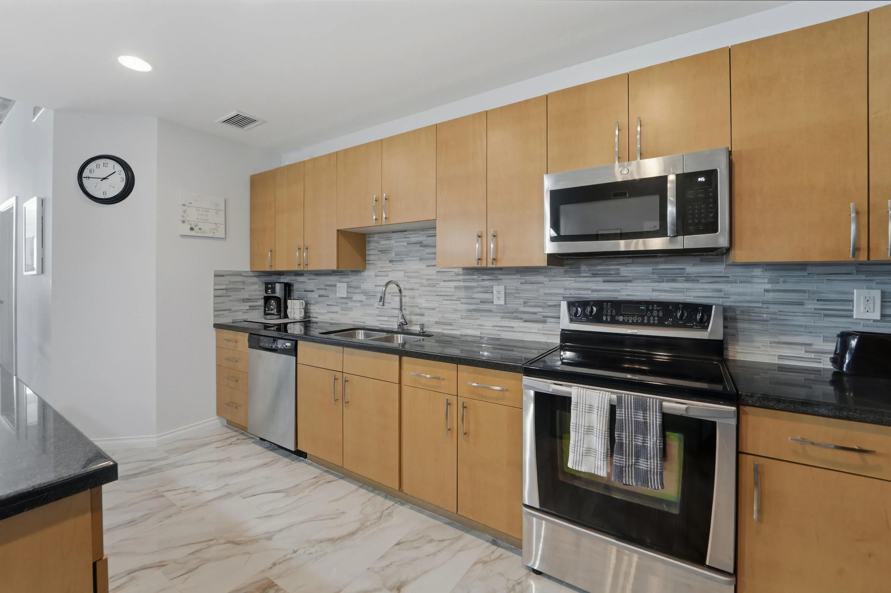 Open-concept kitchen with ample cabinetry, pantry, and island