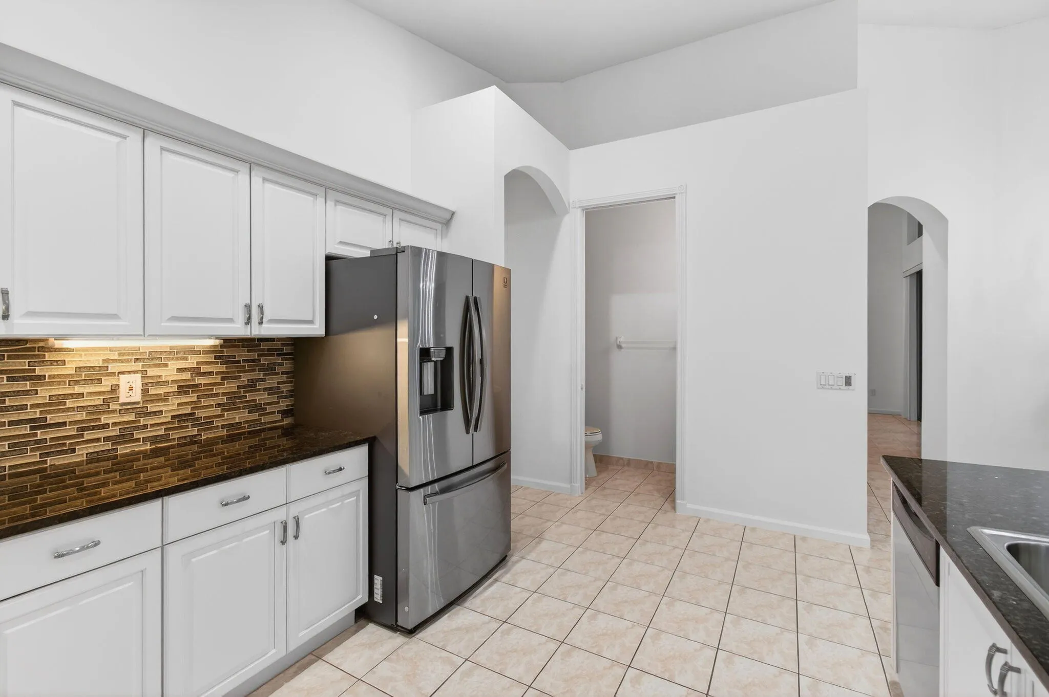 A Powder Room for guests is just off the kitchen