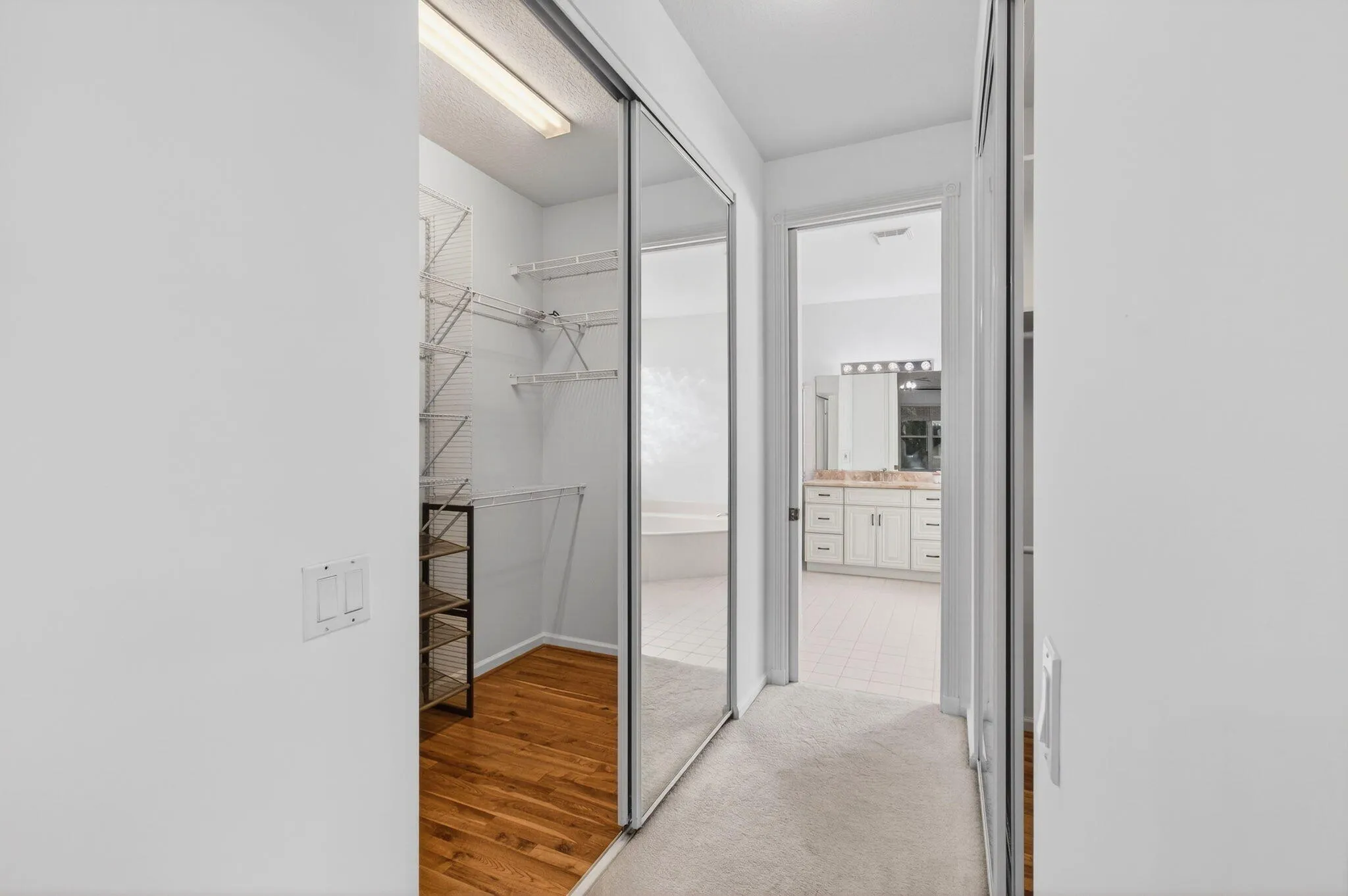 Hallway with walk in closets leads to enSuite
