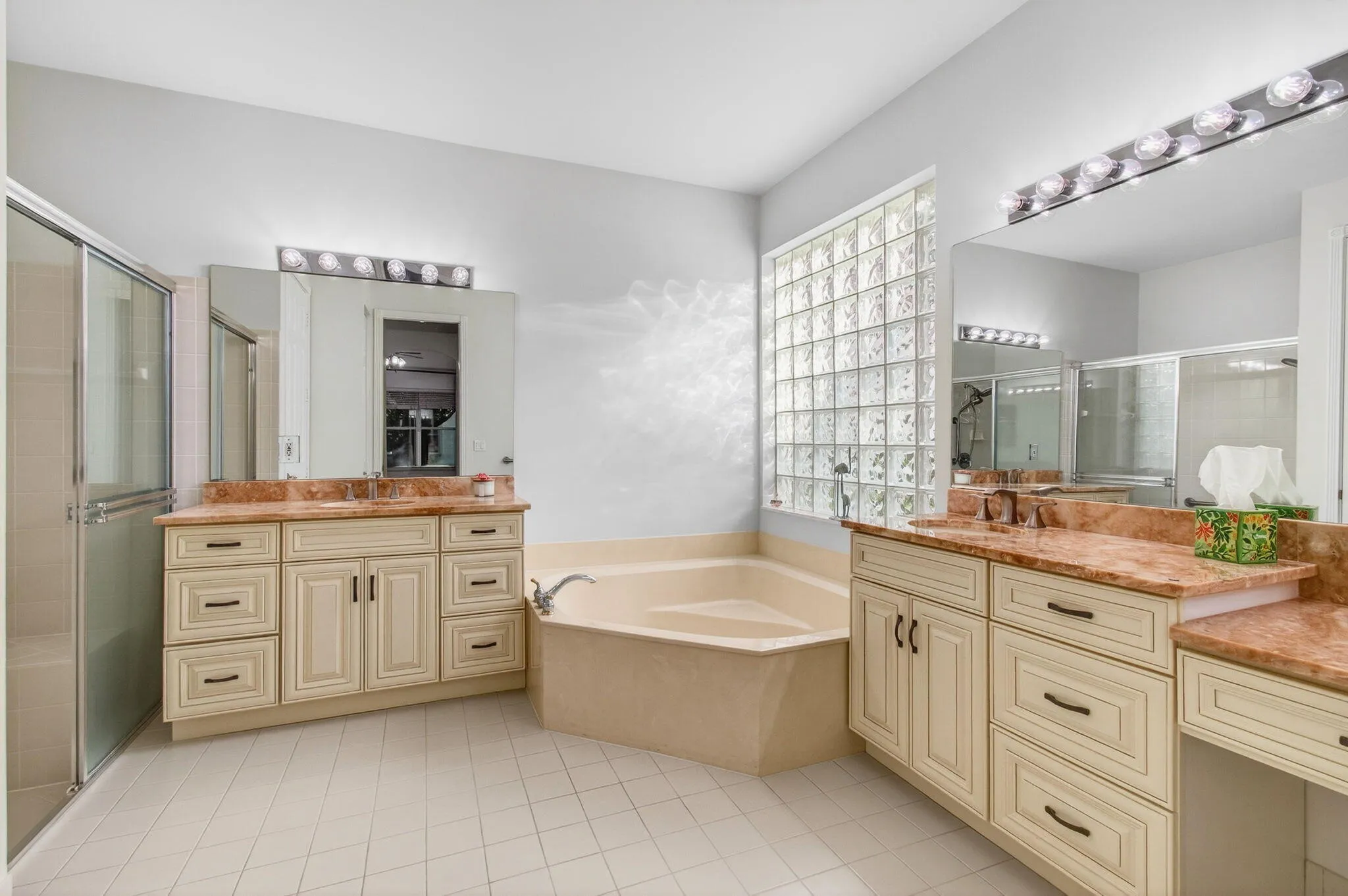 Primary enSuite features upgraded granite and cabinetry, walk-in shower