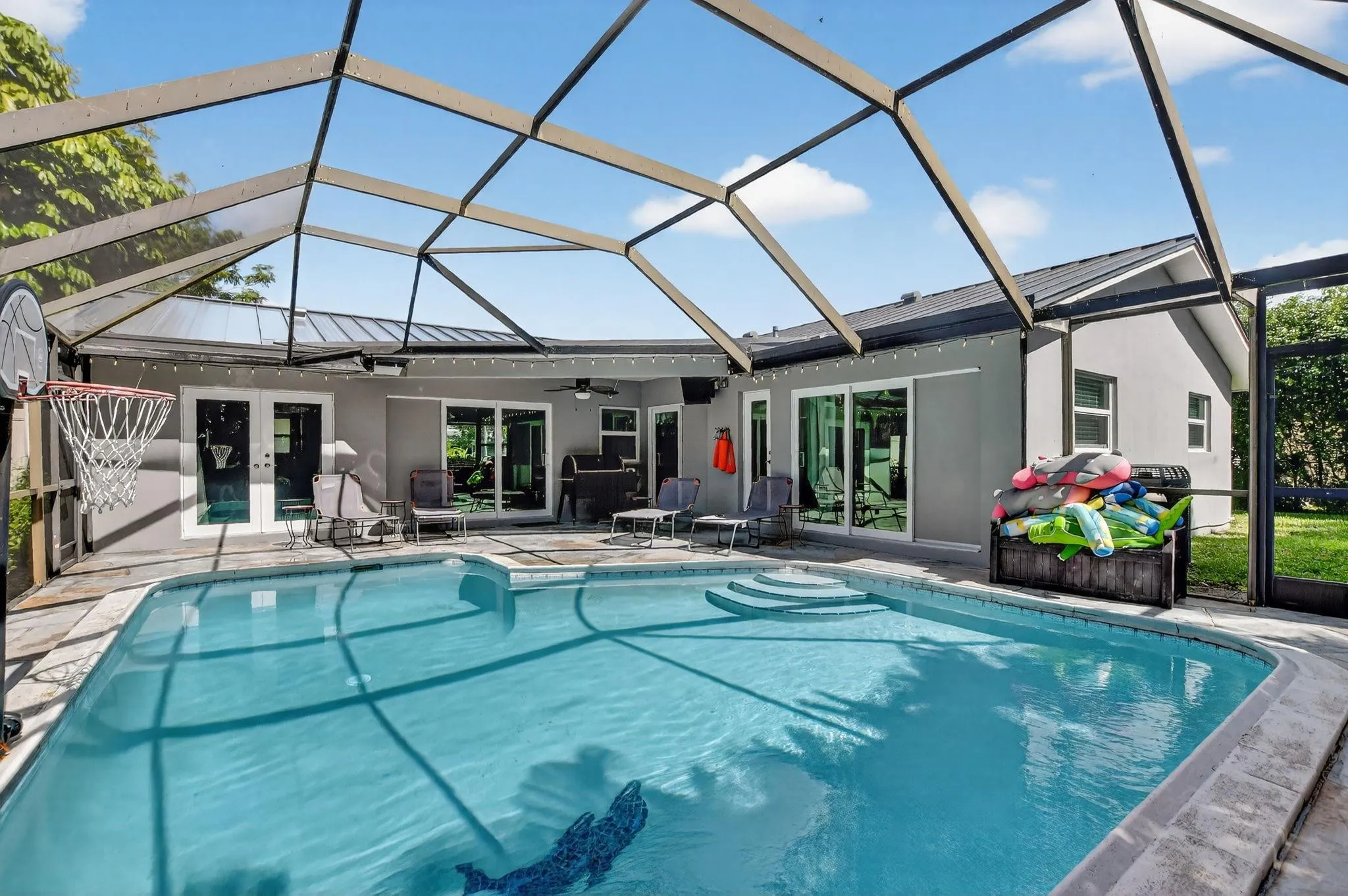 Sparkling pool with a hurricane rated screen enclosure