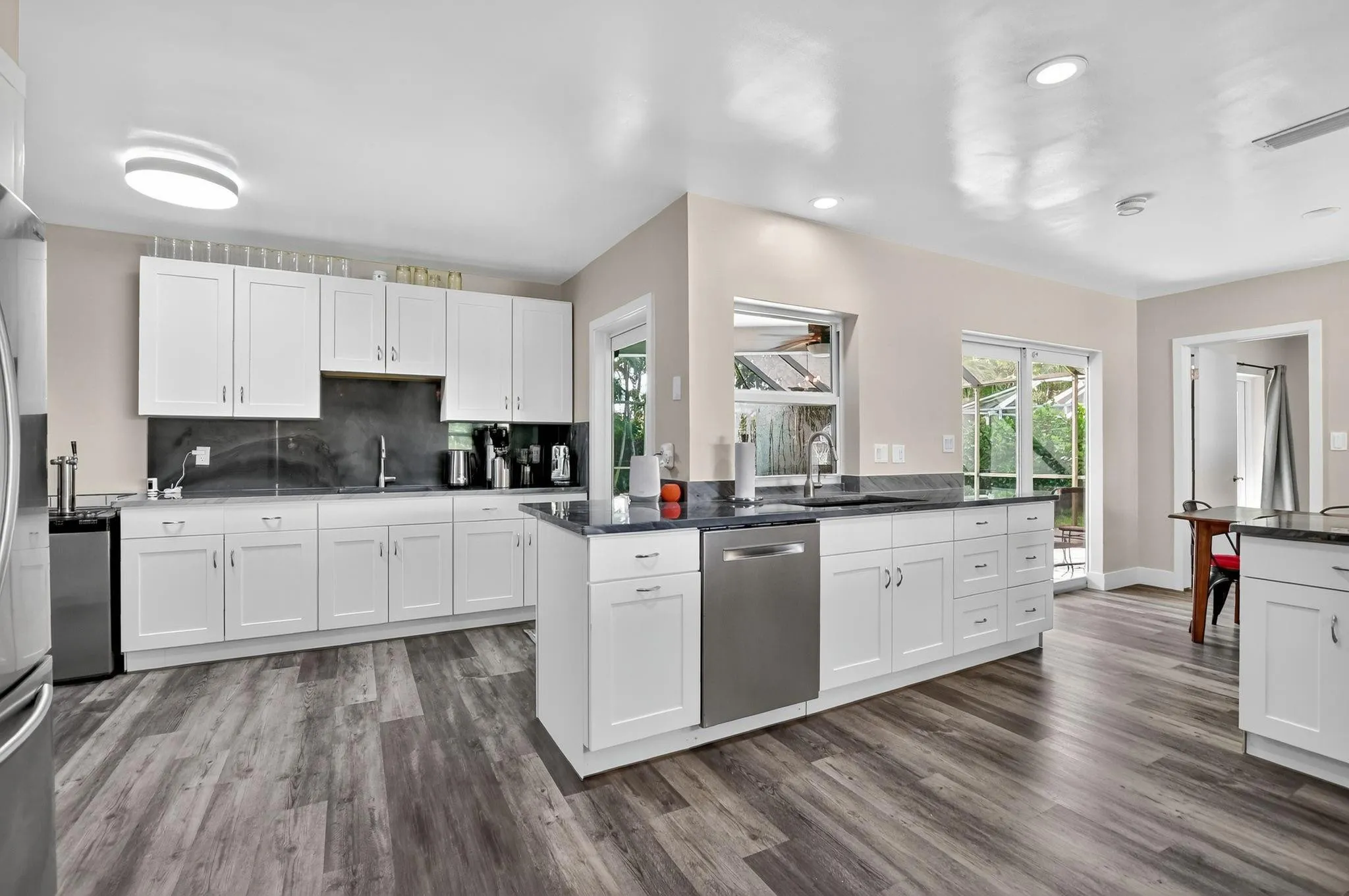 Open kitchen with a free flowing layout; expansive countertops and plenty of cabinets for storage!