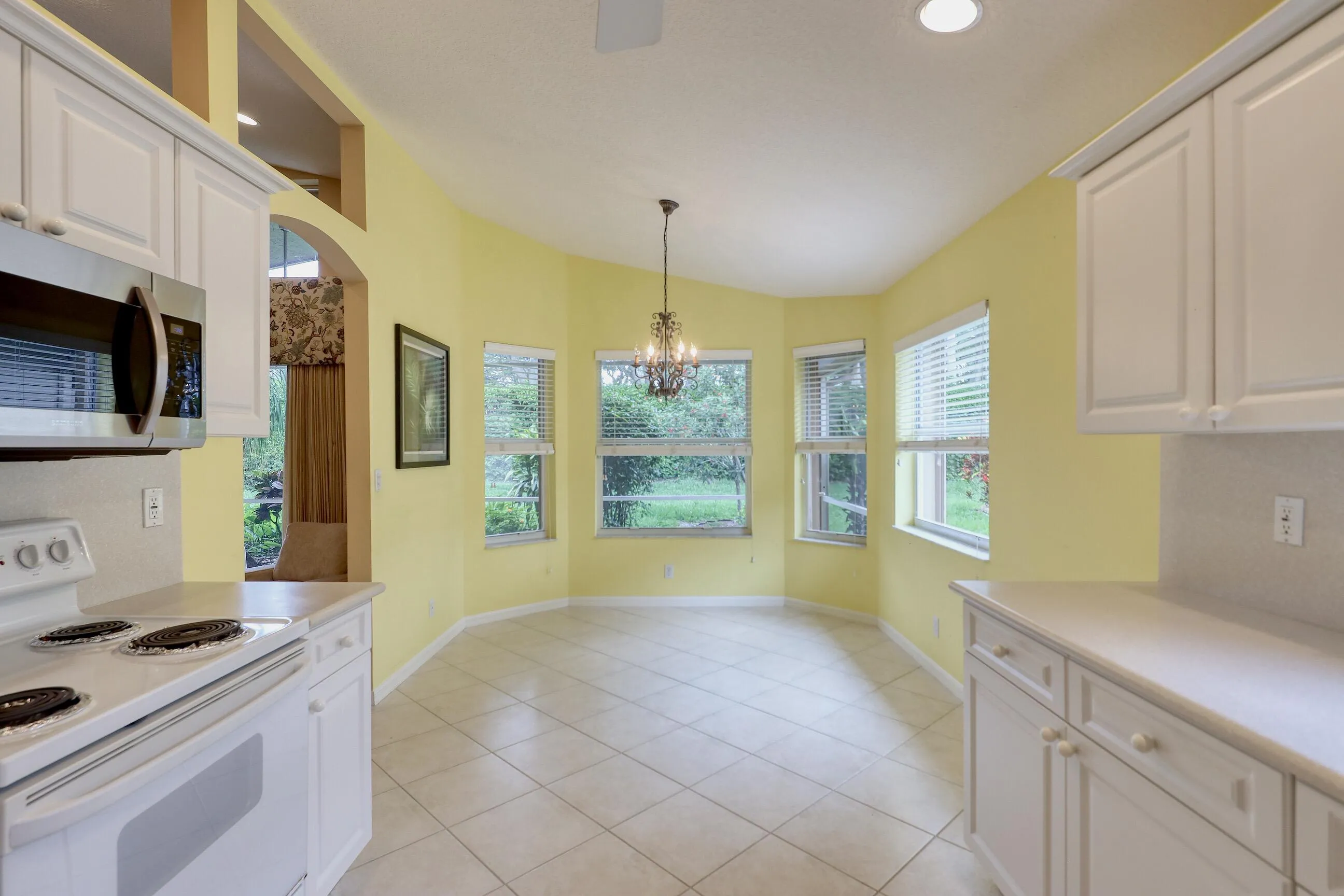 Move in ready home in Bellaggio featuring 2 bedrooms plus den, screened lanai, lake park views and pet friendly living.