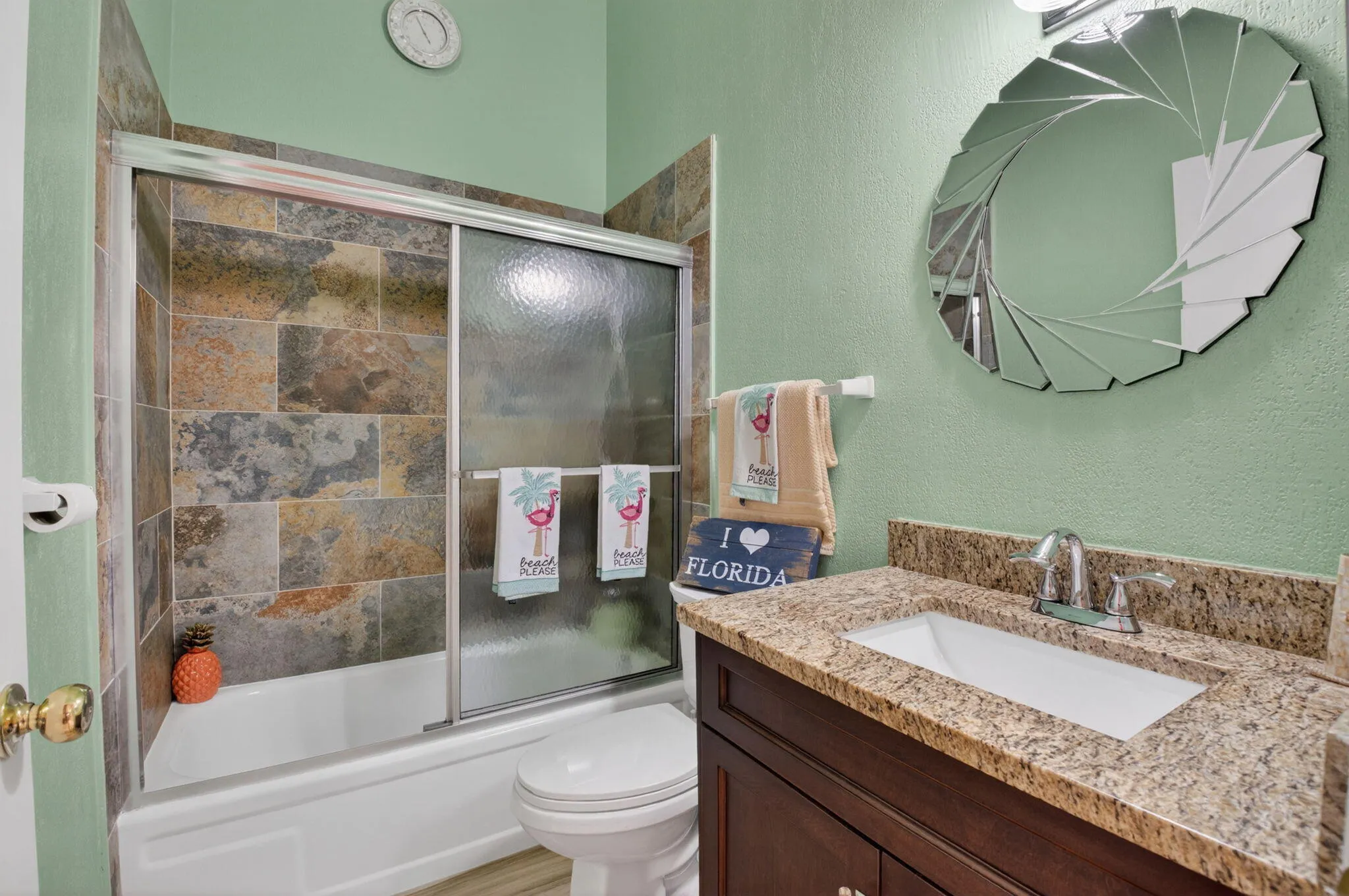 Guest bath features counter height vanity with undermount sink. Stall shower/tub with new tiles.