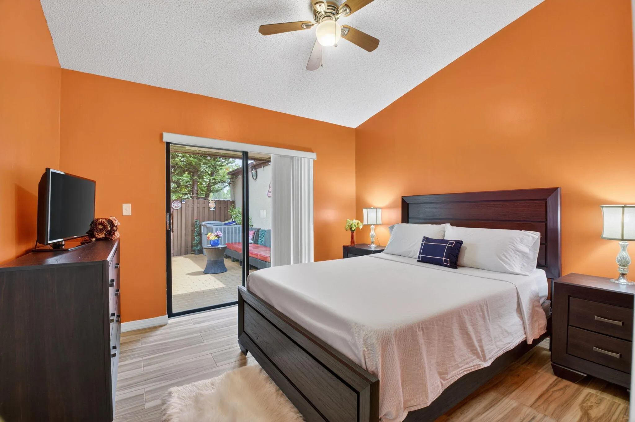 Guest bedroom has bright exposure overlooking the courtyard.