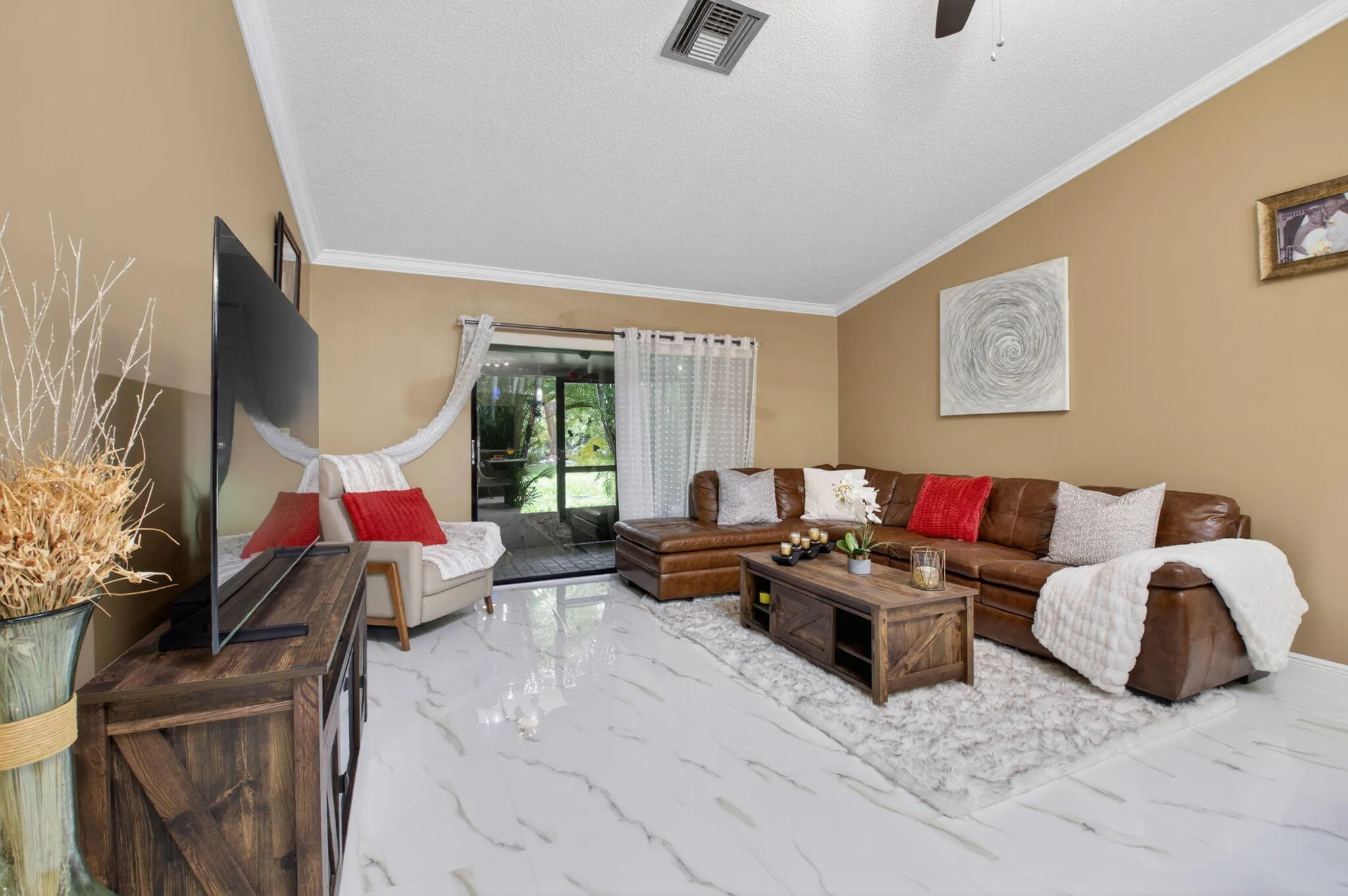 Large family room boasts crown molding on the vaulted ceiling- plenty of room for movie nights.