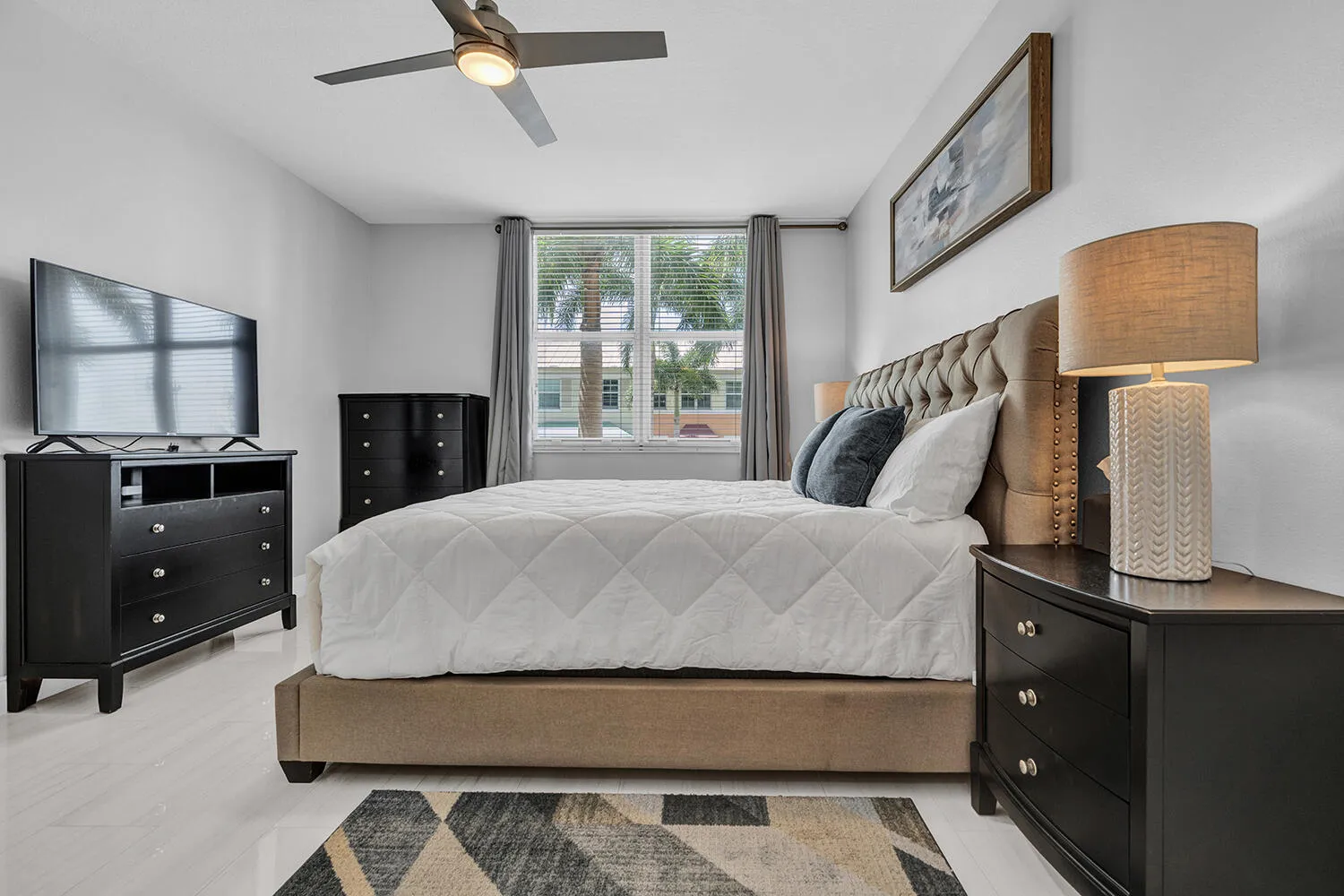 Primary Bedroom with King Size Bed, Large TV, and Walk-in Closet