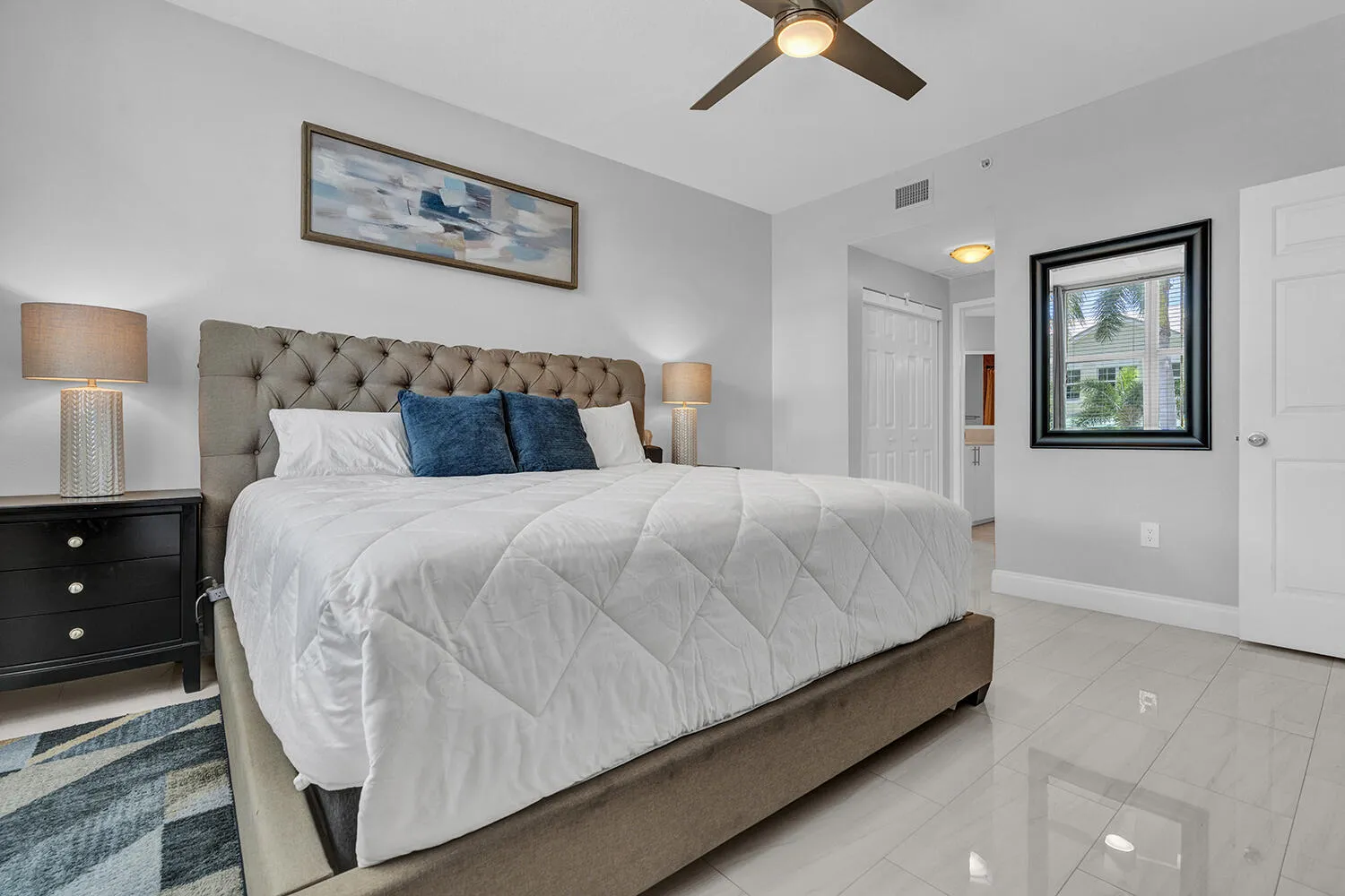 Primary Bedroom with King Size Bed, Large TV, and Walk-in Closet