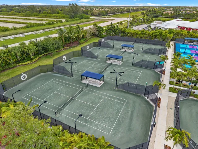 Lighted Har-Tru tennis courts with covered viewing areas, perfect for competitive play, lessons, and social gatherings.