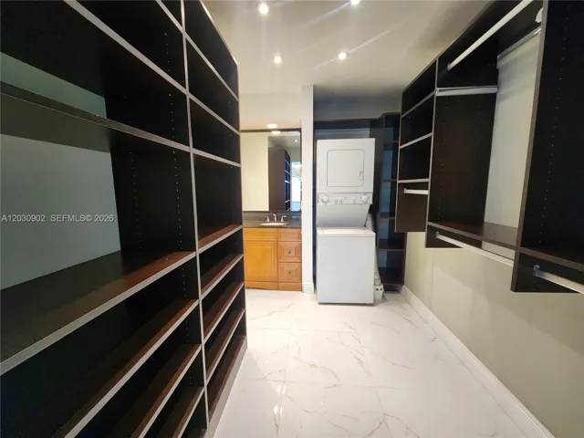 Expansive Walk-In Closet Featuring Custom Wood Built-Ins, Designed for Maximum Storage and Organization.
