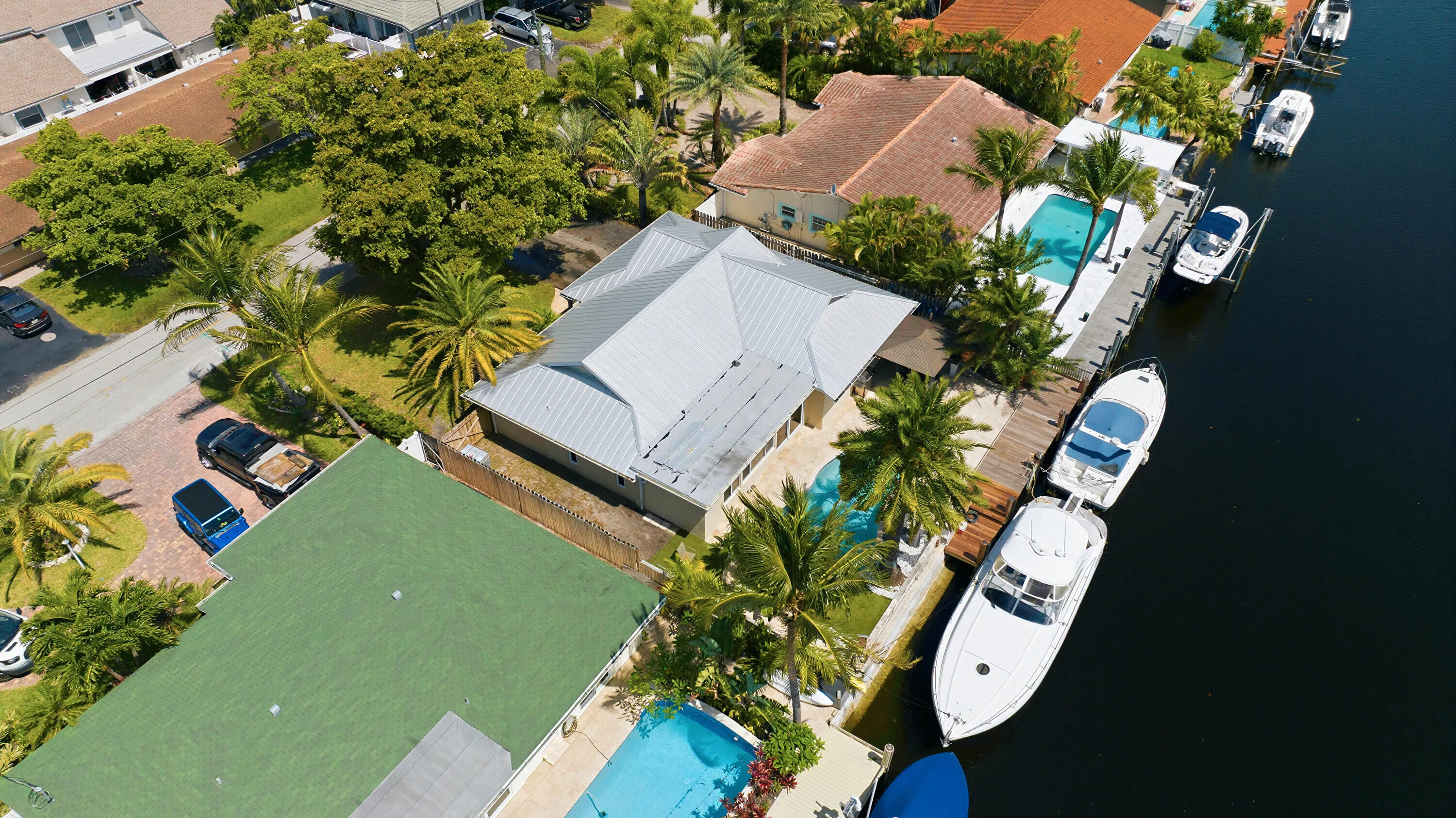 Aerial of the 40' Dock, 70' Seawall, Freeform Pool with Rock Waterfall, Covered Patio Space for Fail Safe Outdoor Patio Perfect for Enteraining. Your Ocean Access, Waterfront Lifestyle at it's Finest!