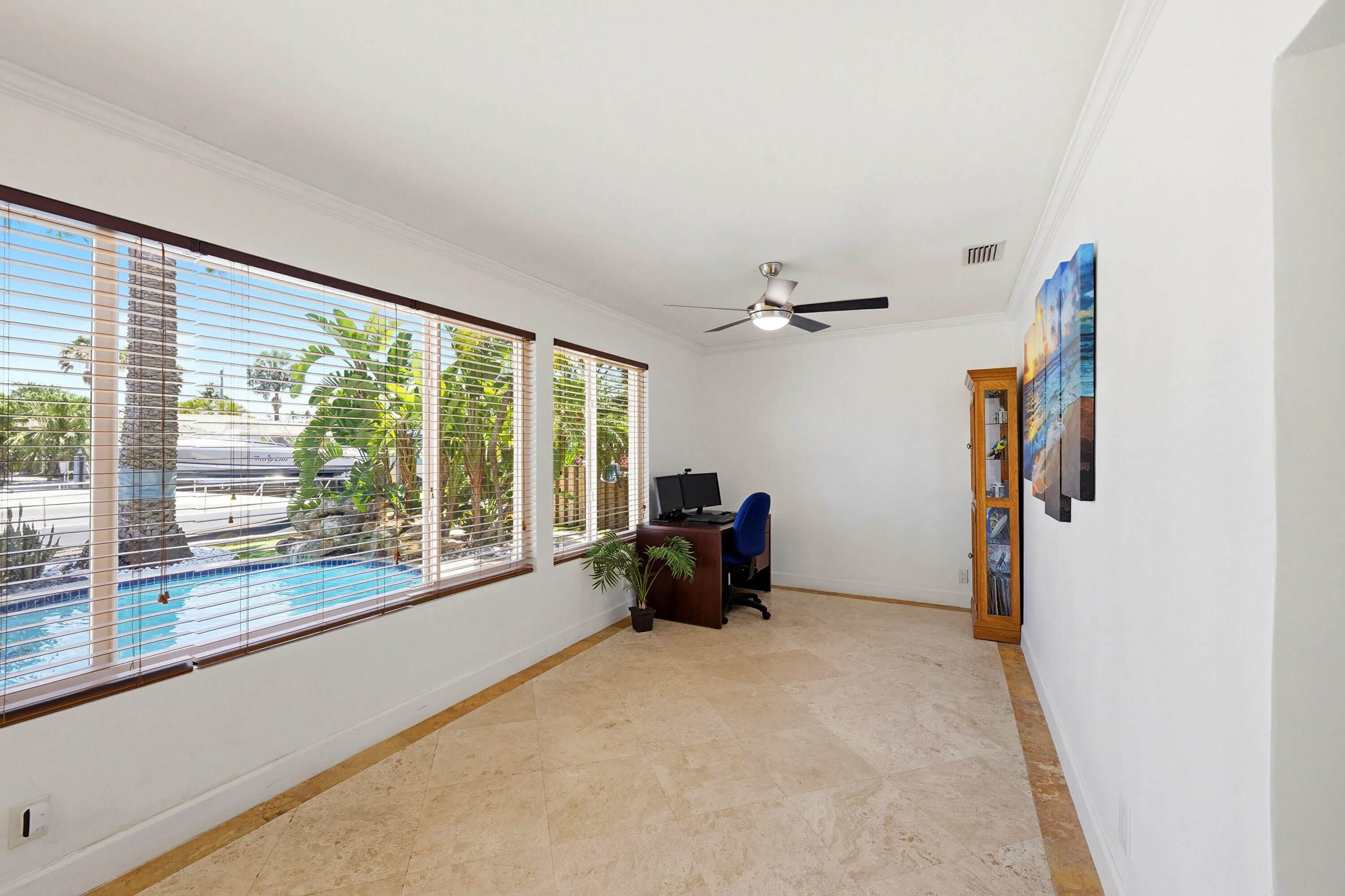 East Facing Florida Room Looks Over the Backyard, Pool, Rock Waterfall, Covered Patio, 40'Dock, 70' Seawall & Ocean Access.