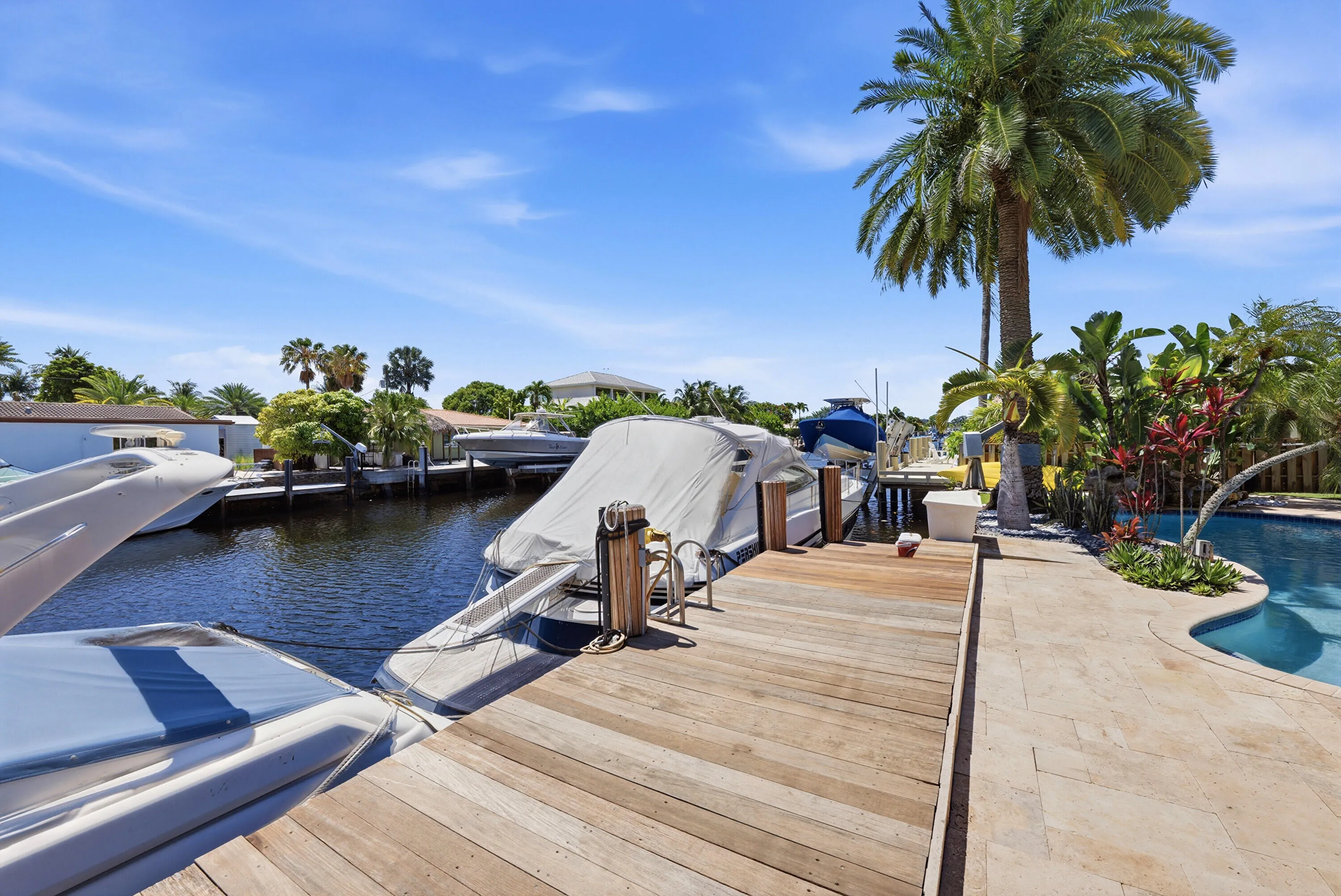 Ocean Access from Your Waterfront Oasis with a 40' Dock, 70' Seawall Resurfaced 2026 and includes a Lift. All This Poolside in Your Own Backyard.
