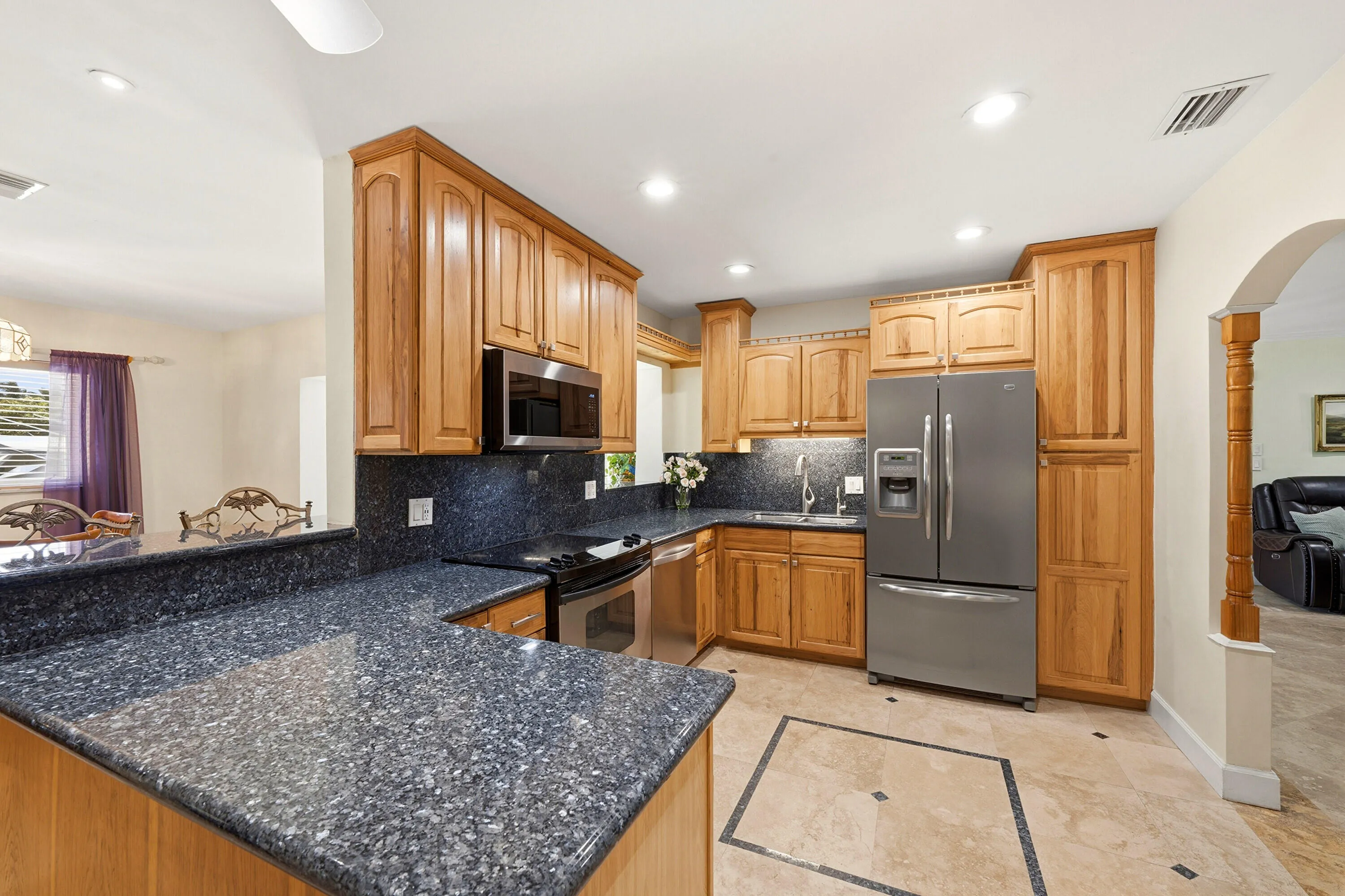 Your HUGE Kitchen includes SS Appliances, Tall Custome Cabinets with Crown Molding, LED Lighting, 18" Travertine Tile Floors, Granite Countertops, 2 Snack Bars with a Pass-Thru for Convenience.