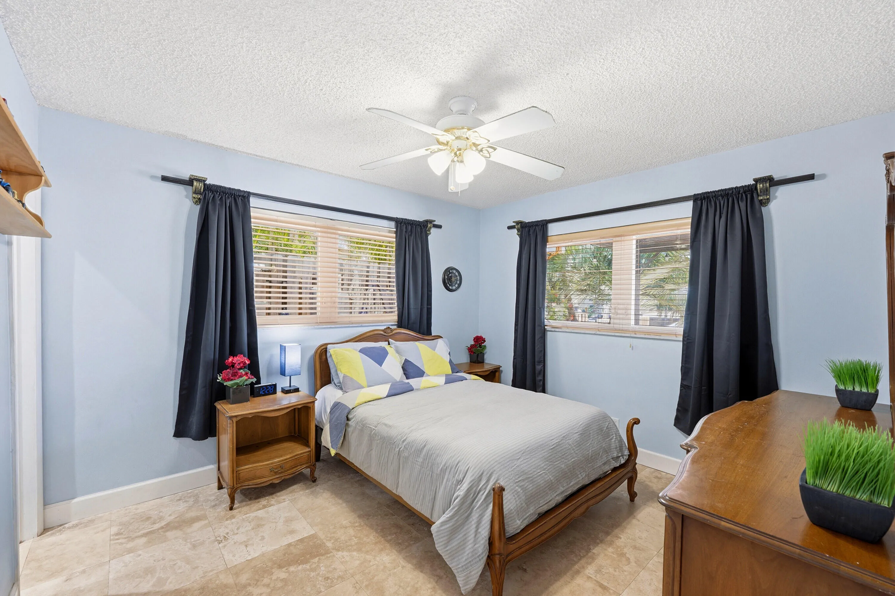 Guest Bedroom is Poolside with En-Suite Bathroom & Bright Walk-In Closet with Frosted Glass Doors.