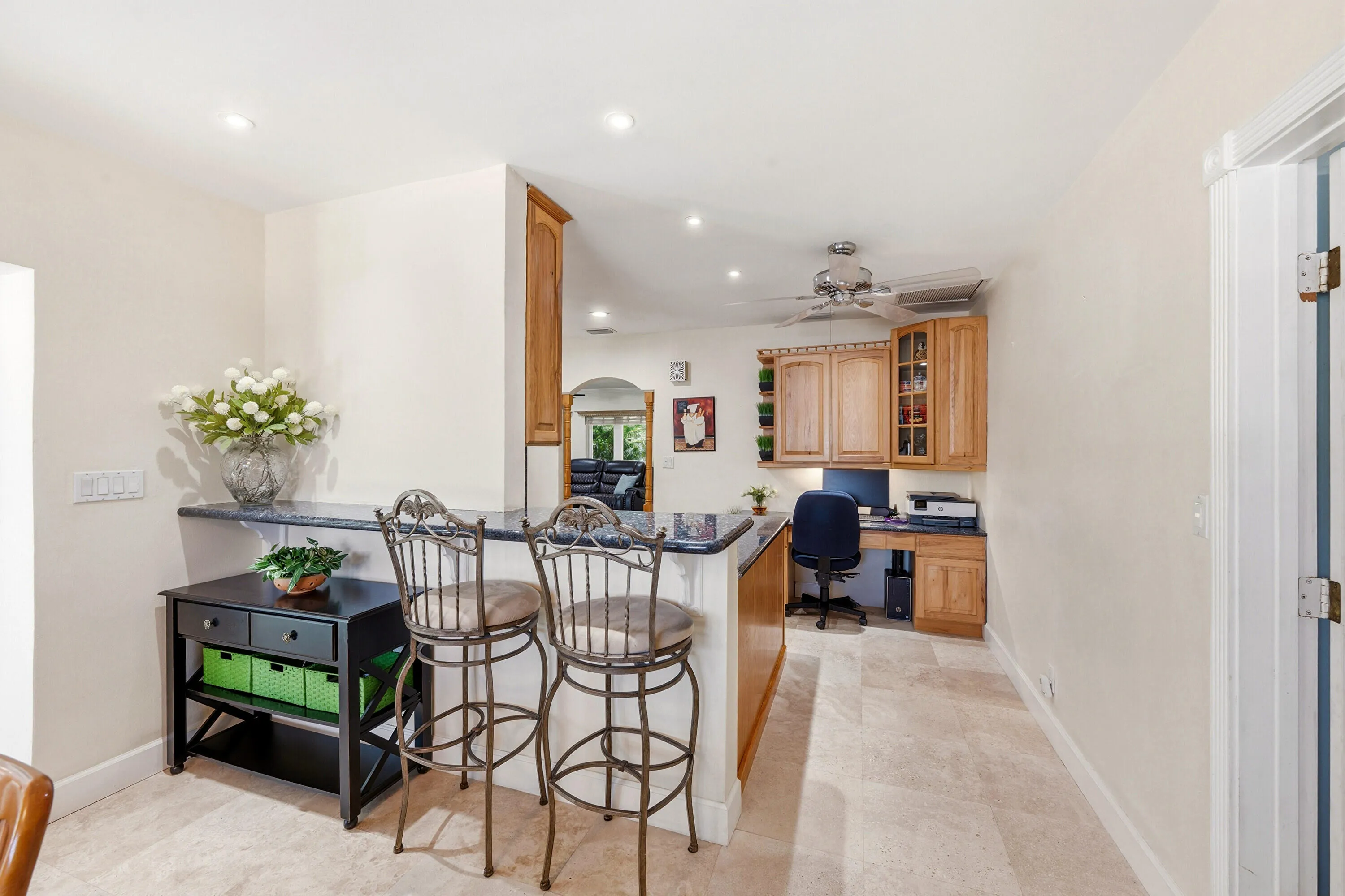 From the Dining Room to The Kitchen Includes a Snack Bar, Built-In Desk, Custome Cabinets, LED Lighting & 18" Travertine Tile Floors.